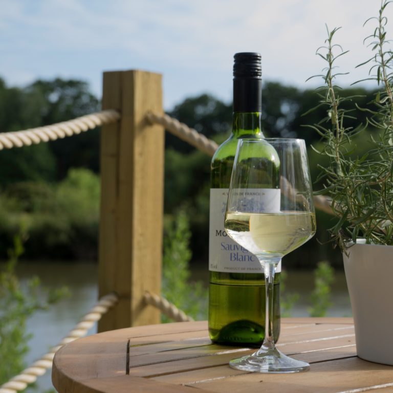 Drinking wine, outside a Plankbridge shepherd's hut, next to a lake